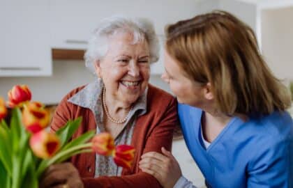 Older woman at home with a nurse who is supporting her through live-in care