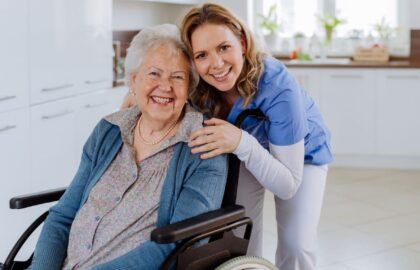 Senior and in-home caregiver smiling